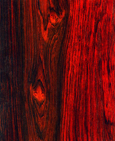 Close up of reddish wood with dark grain lines