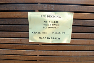 Wood planks in a bundle with a sign that reads “Ipe 2x6; Made in Brazil”