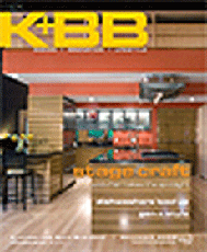 Magazine cover depicting a photograph of a kitchen with a wood floor and black chairs and table to the left, with the letters "K+BB" in the upper left corner of the image.