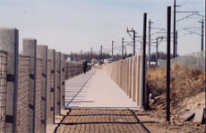 Boardwalk with concrete railing on the left