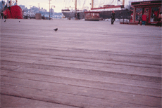 Wood decking in front of tall ships