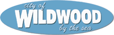 Wildwood, NJ Logo consisting of the words "city of" in script above the word "Wildwood" in heavy white text and "by the sea" in script below, on a blue oval